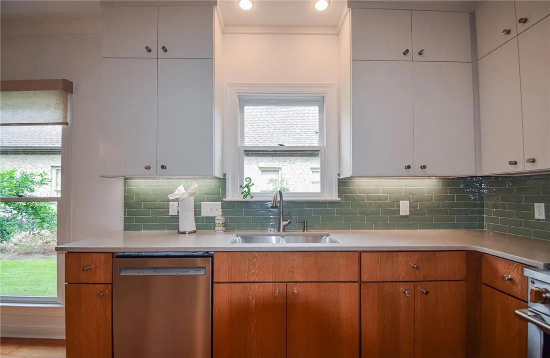 Gleaming stone countertops and warm wood cabinets define this bright culinary workspace.