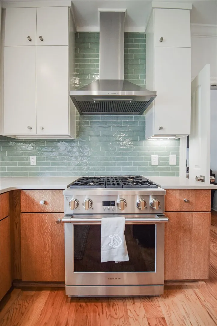 Gleaming hardwood floors support custom cabinetry and a professional-grade range.
