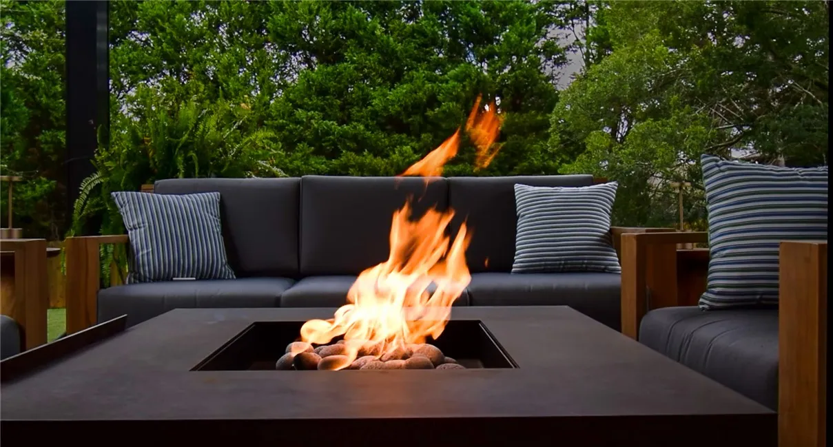 Lush mature trees form a beautiful privacy backdrop behind a built-in outdoor lounge area.