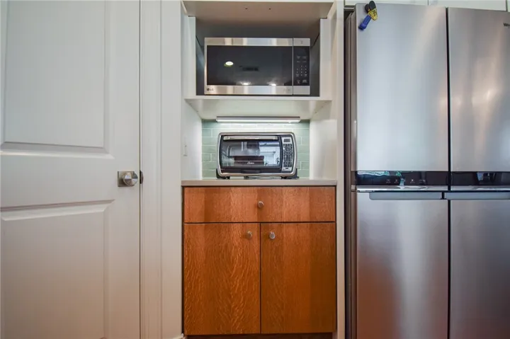 Custom cabinetry and built-in appliances maximize storage efficiency in this kitchen nook.