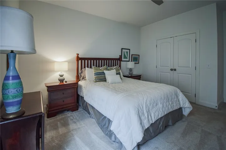 Plush carpeting anchors this inviting space featuring a large closet with double doors.