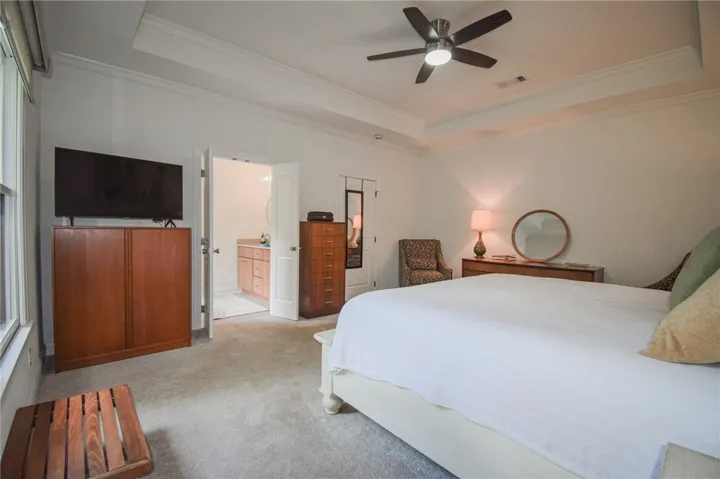 Plush carpeting and a classic tray ceiling define this restful owner suite.
