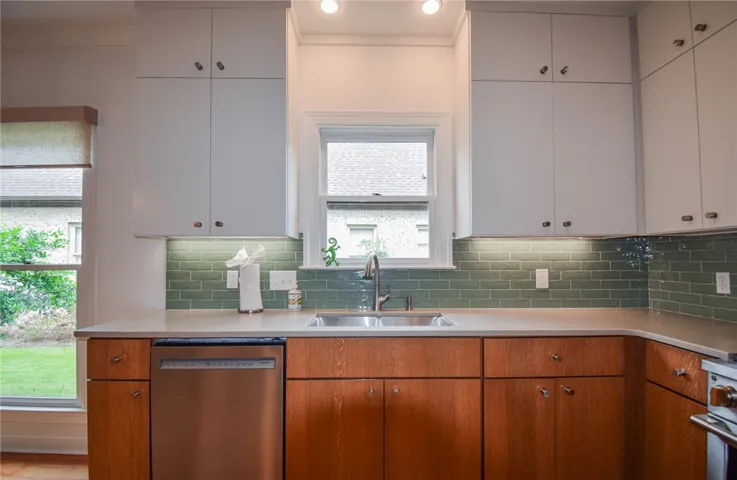 Gleaming stone countertops and warm wood cabinets define this bright culinary workspace.