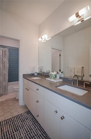 Clean lines and durable stone counters define this double vanity bathroom.