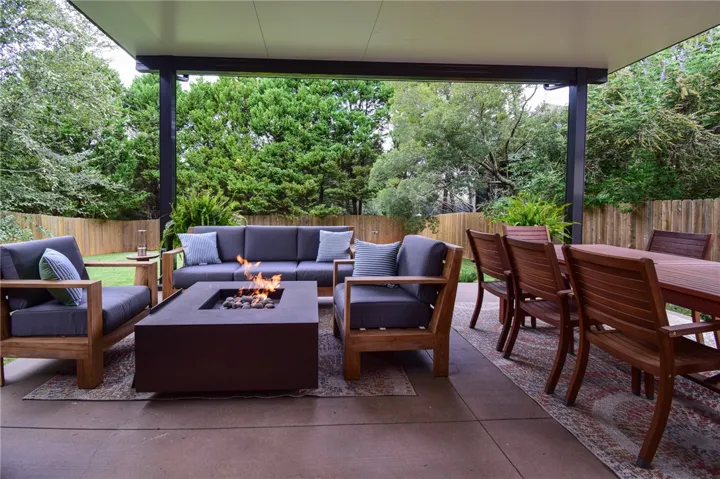 A spacious covered patio provides a seamless transition to the fenced backyard.