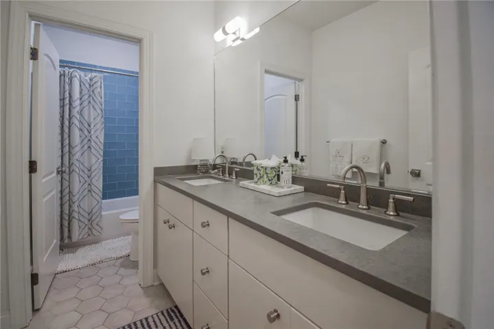 A spacious double vanity and custom tile flooring highlight this bathroom design.