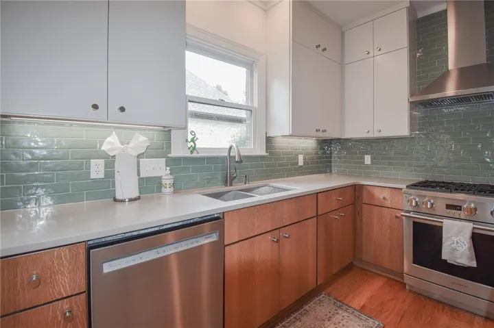 Gleaming stone countertops and a classic subway tile backsplash accent this chef's kitchen.