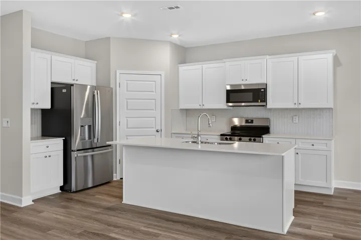 Glass tile backsplash, quartz countertops and Large walk-in pantry