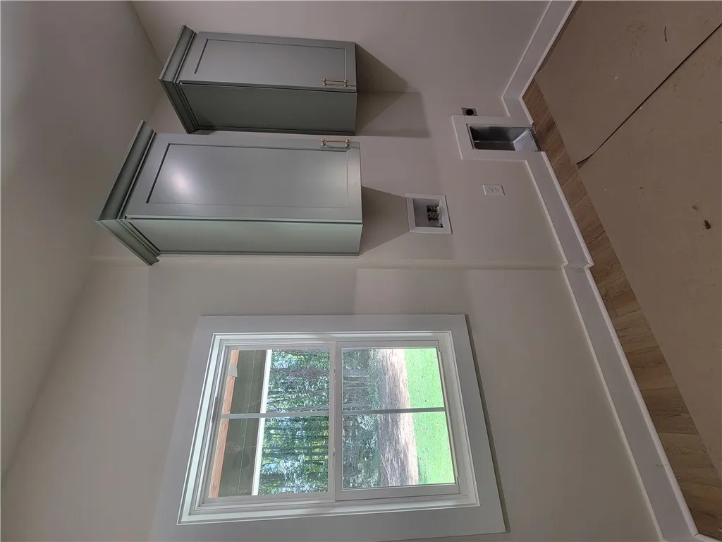 Crown-molded cabinetry and a large window overlooking the yard complete this functional utility space.