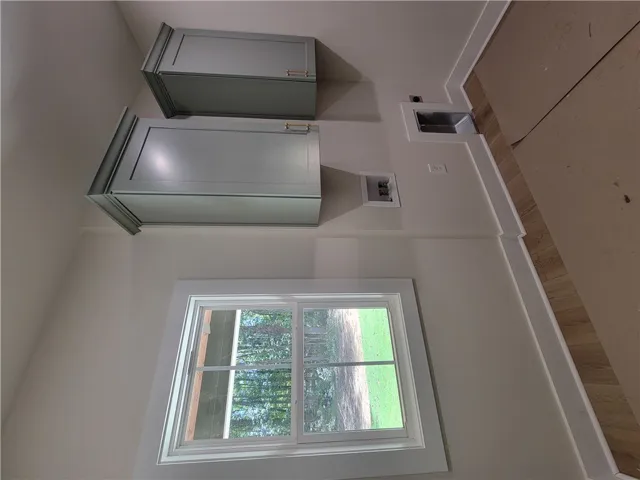 Crown-molded cabinetry and a large window overlooking the yard complete this functional utility space.