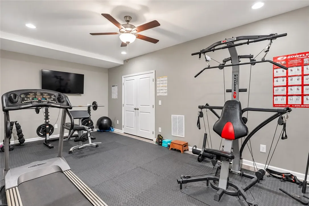 Recessed lighting illuminates this versatile home gym finished with durable rubber mat flooring.