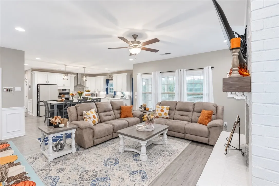 An airy open-concept layout connects the light-filled living area directly to the kitchen.