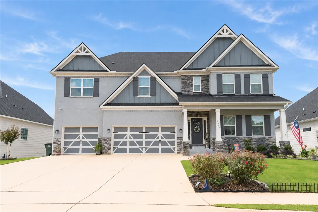 Gable rooflines and stone accents define this modern two-story home with a spacious driveway.