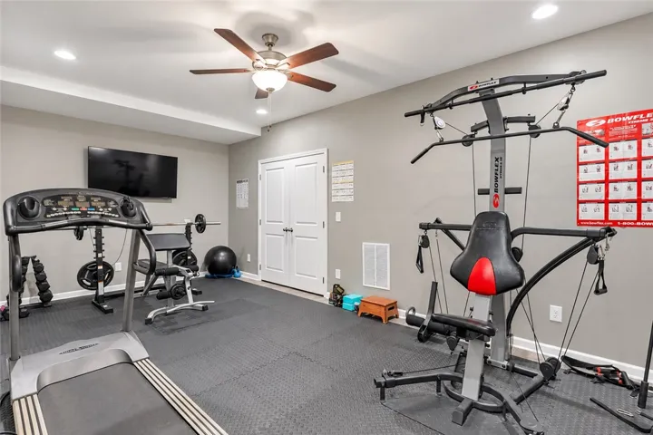 Recessed lighting illuminates this versatile home gym finished with durable rubber mat flooring.