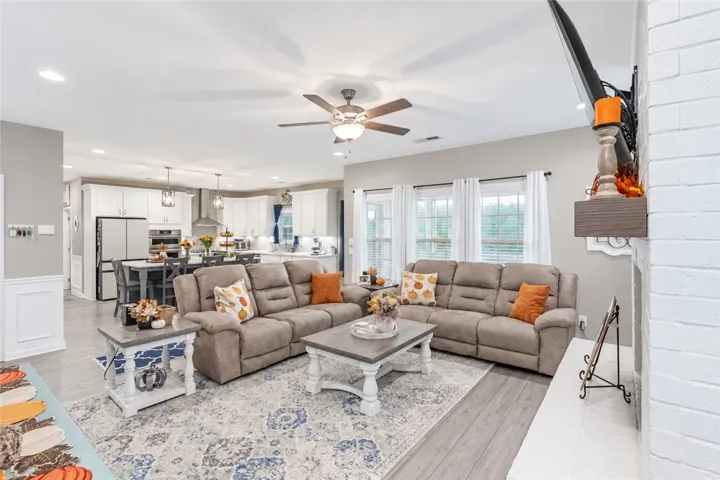 An airy open-concept layout connects the light-filled living area directly to the kitchen.