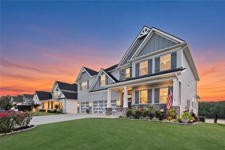 Multi-textured siding, structured gables, and stone accents define this inviting custom home design.