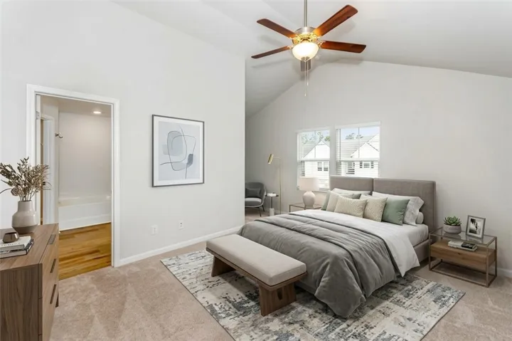 High vaulted ceilings and soft carpeting define this tranquil primary bedroom retreat. "Virtually Staged"