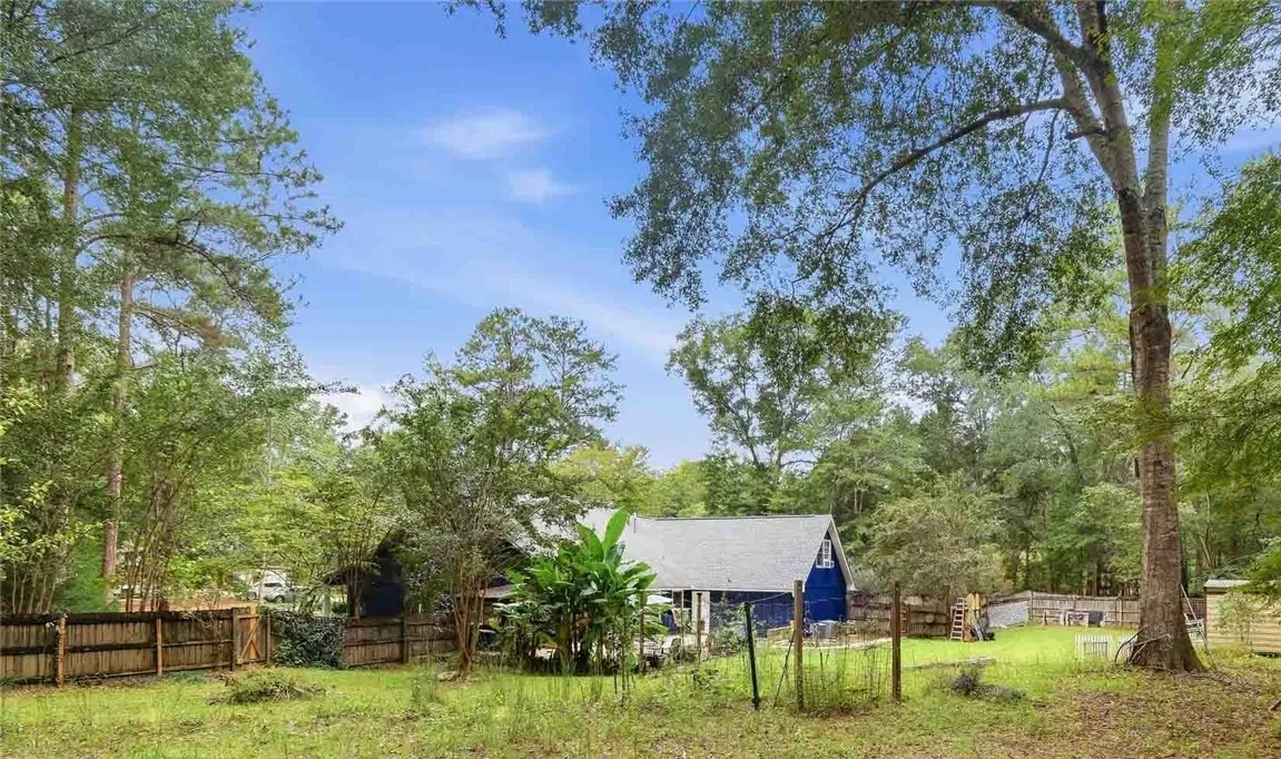 Mature trees frame the spacious backyard of this classic home.
