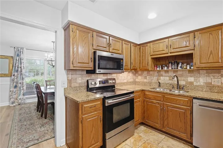 Rich wood cabinetry paired with stone countertops defines this well-appointed kitchen space.