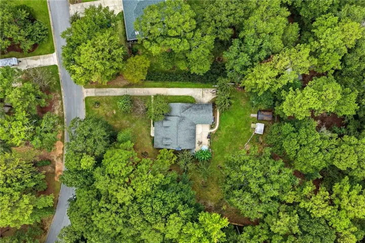 Lush mature trees surround this peaceful property, offering natural privacy and shade.