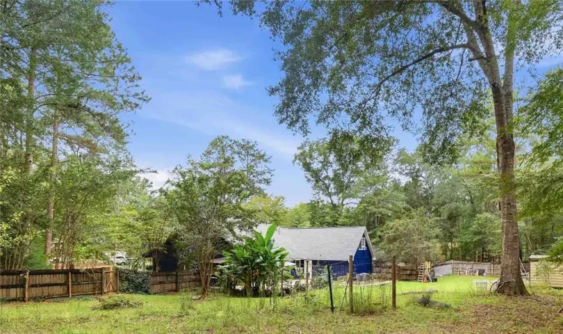 Mature trees frame the spacious backyard of this classic home.
