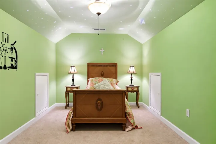 Angled ceilings and cozy carpeted flooring define this unique secondary bedroom space.