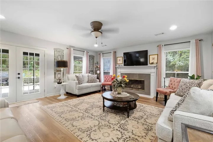 Warm wood flooring and a classic fireplace define this inviting living​​‌​​​​‌​​‌‌​‌‌​​​‌‌​‌​‌​‌​​​‌​​ space.