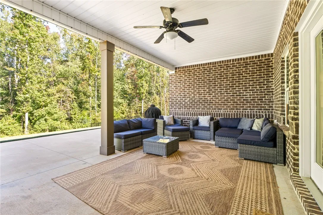 large extended back patio that over looks the wood green space