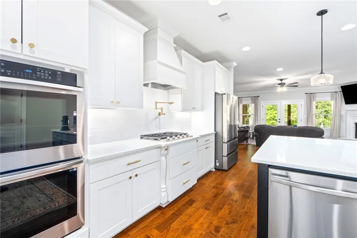 A beautifully designed open-concept kitchen, with gas appliances quartz countertops, upgrades galore
