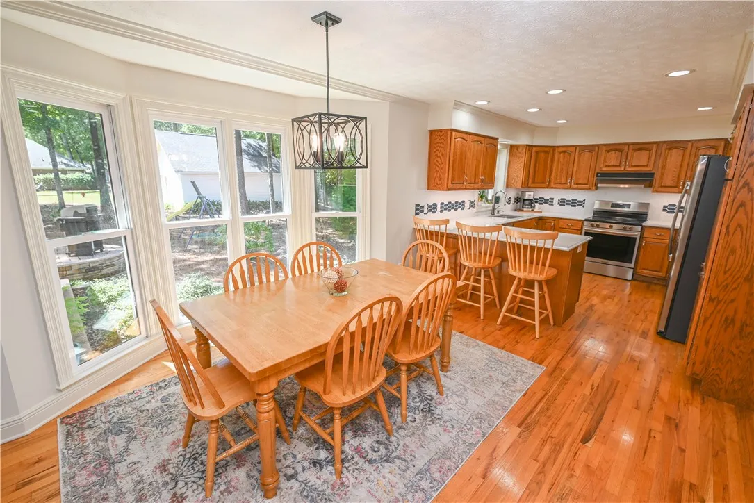 Beautiful sand and finish hardwoods flow throughout the sunny breakfast area and kitchen.