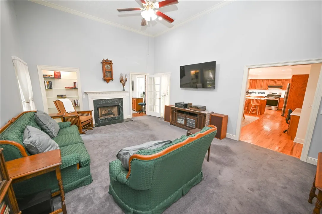 Enormous great room with soaring ceilings opens to kitchen and breakfast area.