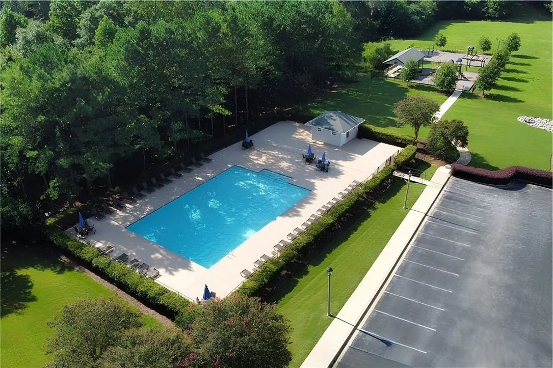 2nd neighborhood pool with playground and greenspace in background.