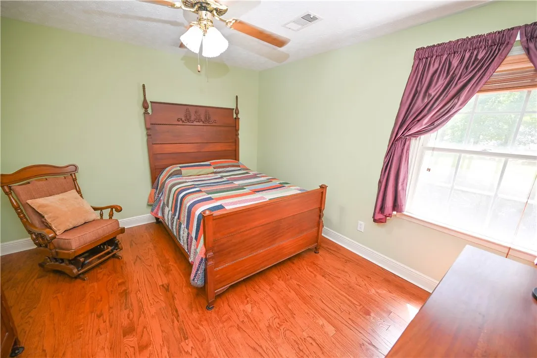 Bedroom 4, also with hardwoods.