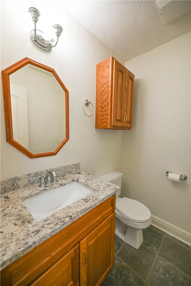 Powder room tucked discreetly off the living area.