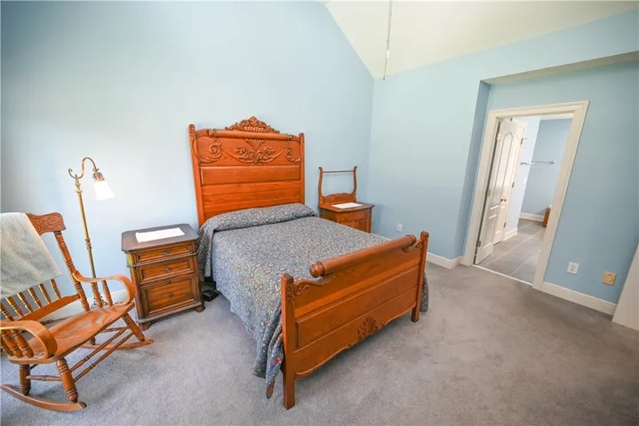 Primary bedroom with en-suite bath in background.