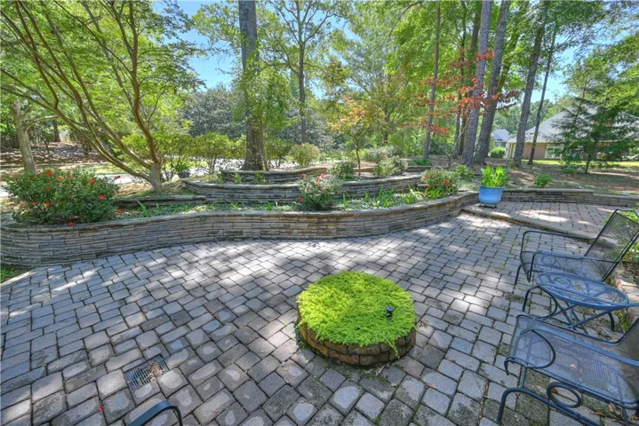 Wrap-around patio surrounded by tiered gardens!