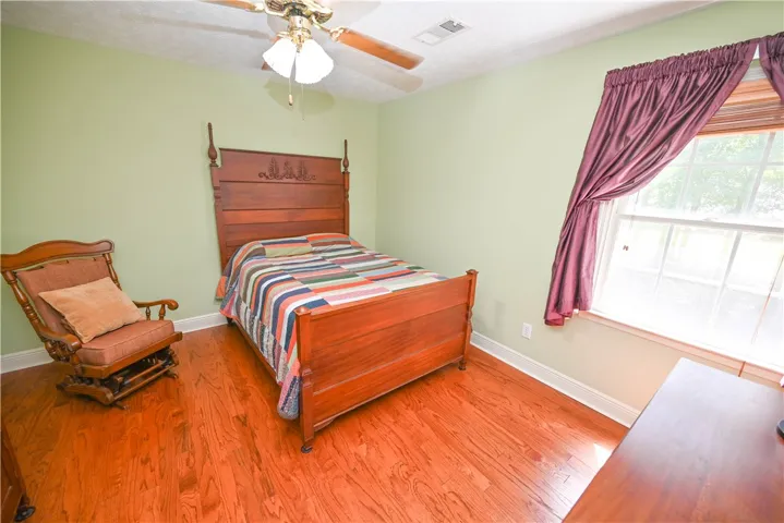 Bedroom 4, also with hardwoods.