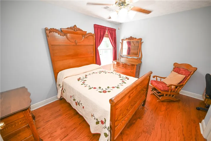 Bedroom 3 with built-in desk and hardwood floors.