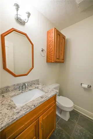 Powder room tucked discreetly off the living area.