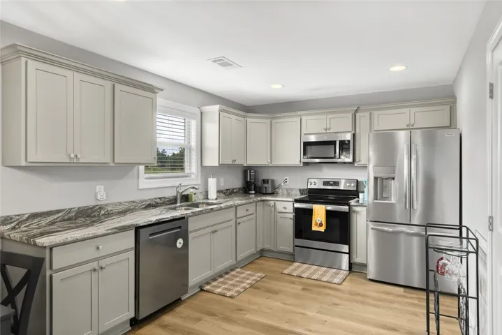 Elegant stone countertops and modern cabinetry highlight this functional culinary workspace.