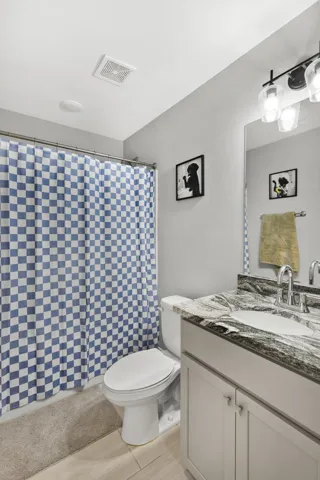 Polished stone counters elevate this contemporary vanity unit.