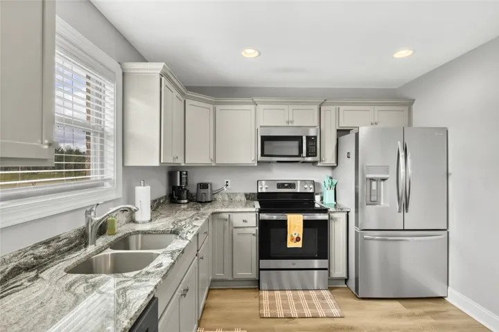 Polished granite countertops and classic cabinetry define this functional culinary space.
