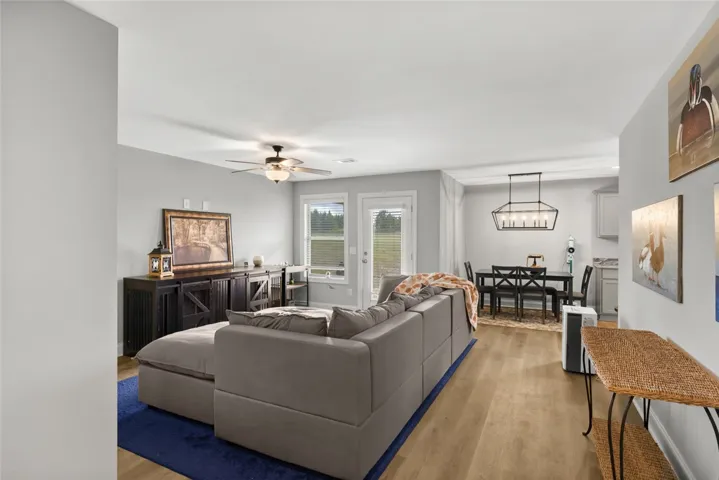 An open floorplan connects the comfortable living area to the adjacent dining space.