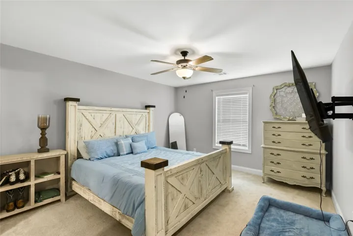 Primary bedroom large enough for a king size bed with additional room.