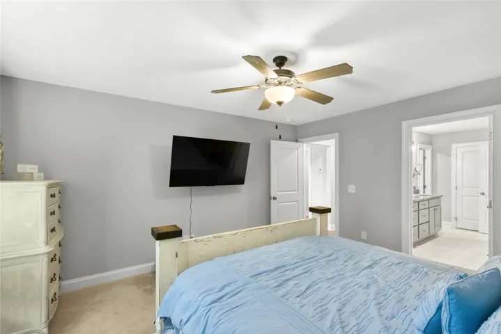 Soft carpeting underfoot anchors this quiet suite connecting directly to a private bathroom.