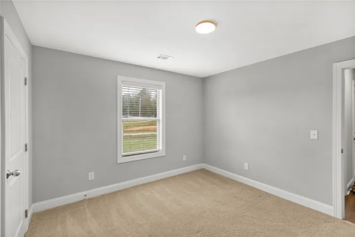 Soft carpet and clean trim define this versatile secondary space.