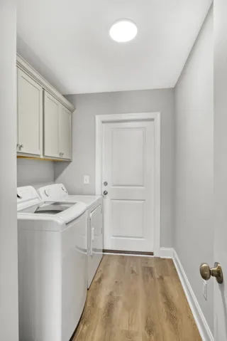 Streamlined cabinetry and classic flooring elevate this dedicated utility space.