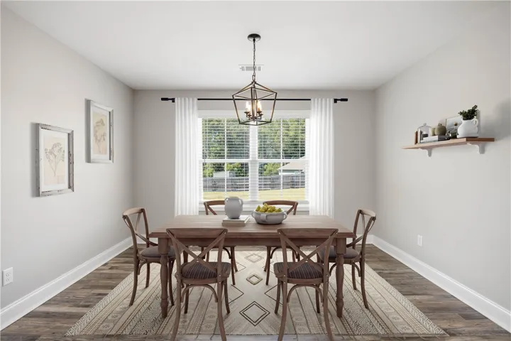 Rich wood flooring and a large window set a welcoming tone in this dining area.