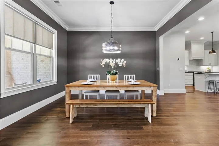 Classic crown molding and rich hardwood floors elevate this formal dining space.