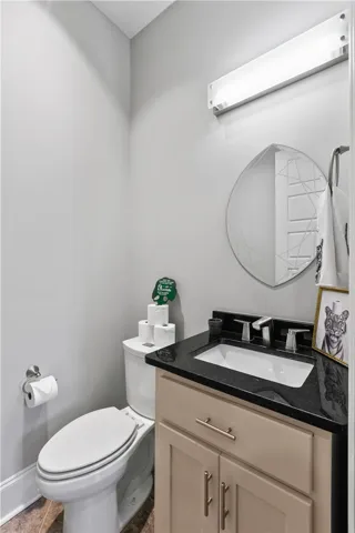 Polished stone counters and clean design elements maximize style in this compact powder room.